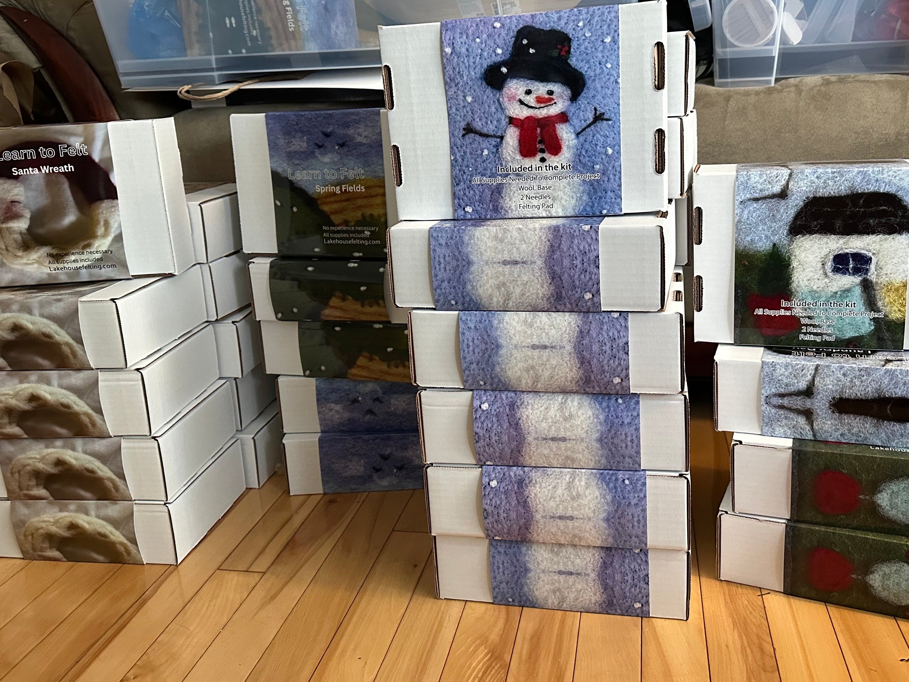 Stack of learn to Felt kits on wooden flor